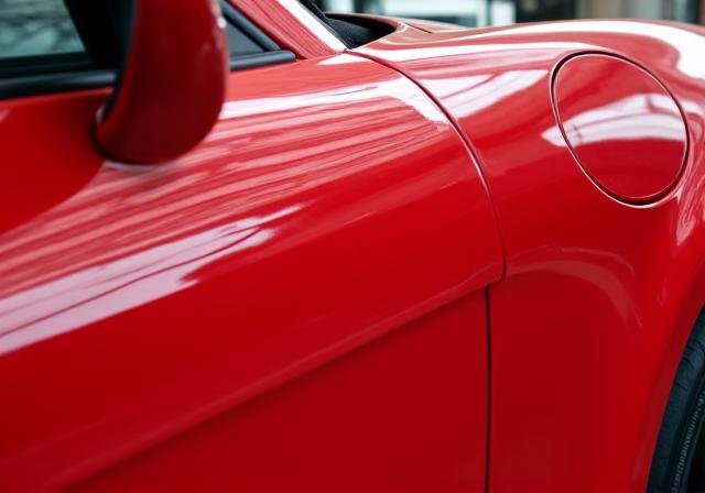 Porsche 911 after paint correction with deep, glossy red paint